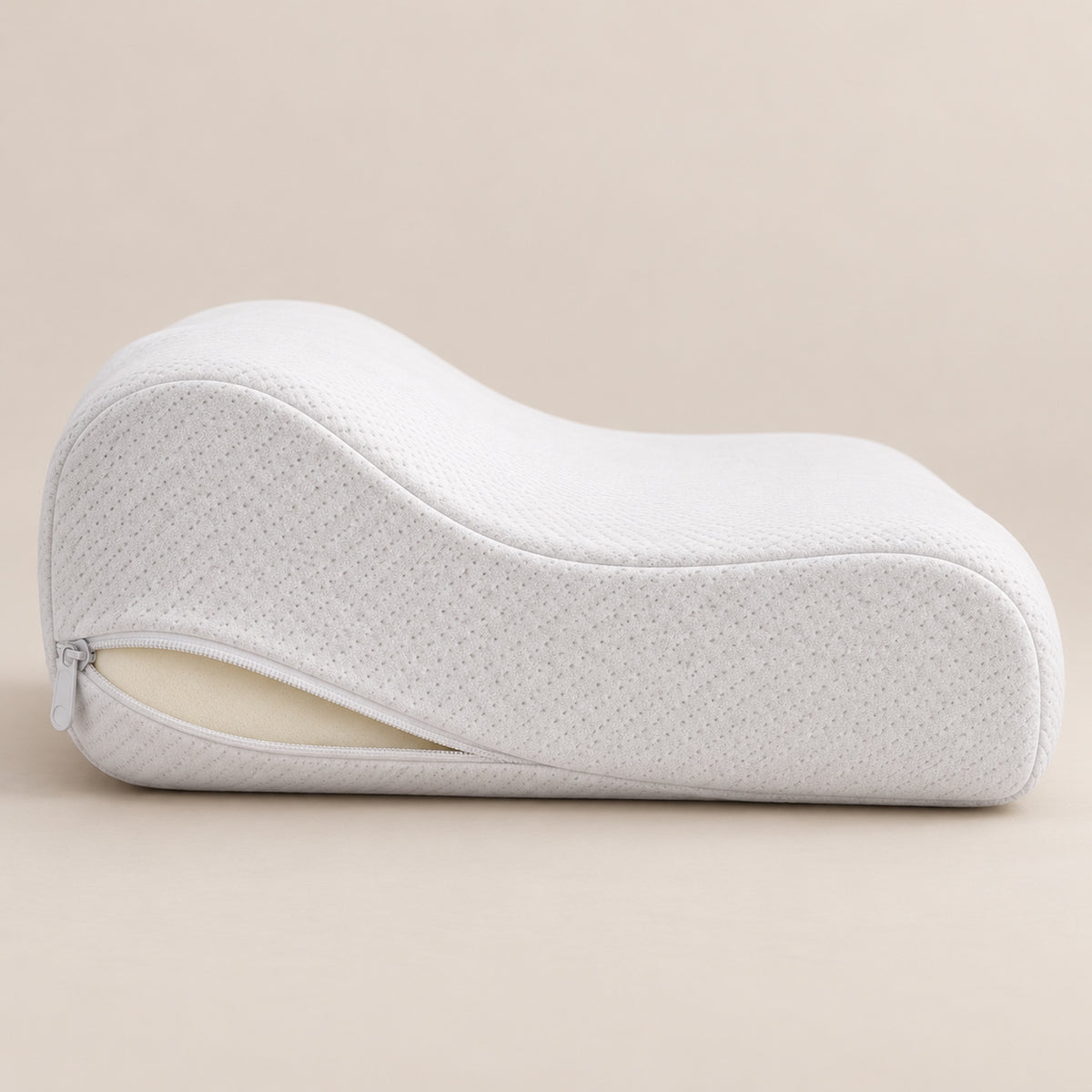 Side view of the contoured pillow with the cover zip open